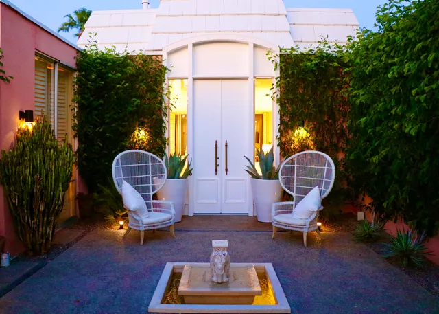 a view of a swimming pool with sitting area and garden