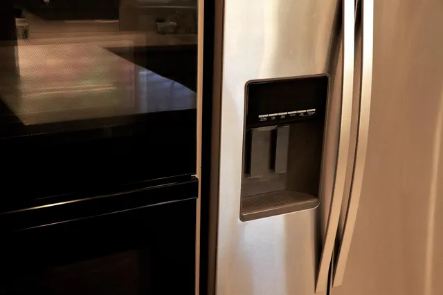 a large bed sitting in a bedroom next to a window