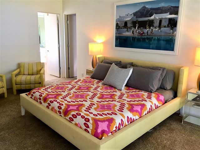 a bedroom with a bed and dresser