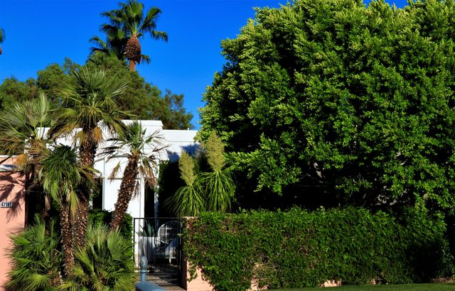 a view of a patio with a table chairs and a fire pit