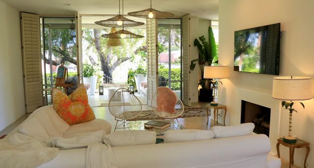 a dining room with fireplace flat screen tv and outdoor view