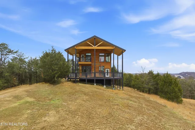 a view of a house with a yard and sitting area