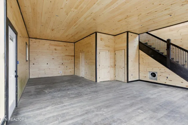 a view of balcony with wooden floor and fence