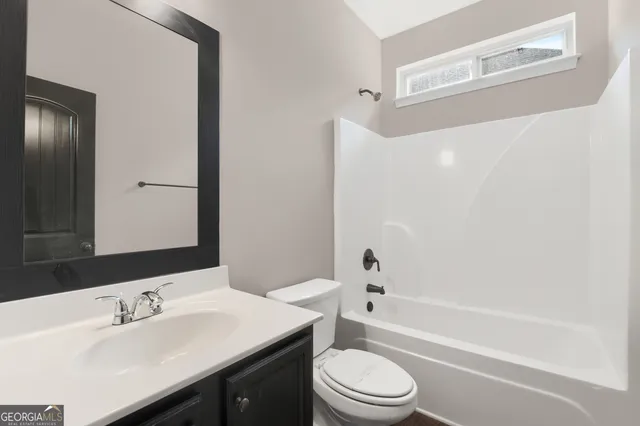 a bathroom with a toilet a sink and a bathtub