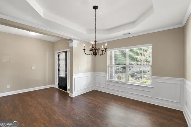 a view of a room with window wooden floor and chandelier