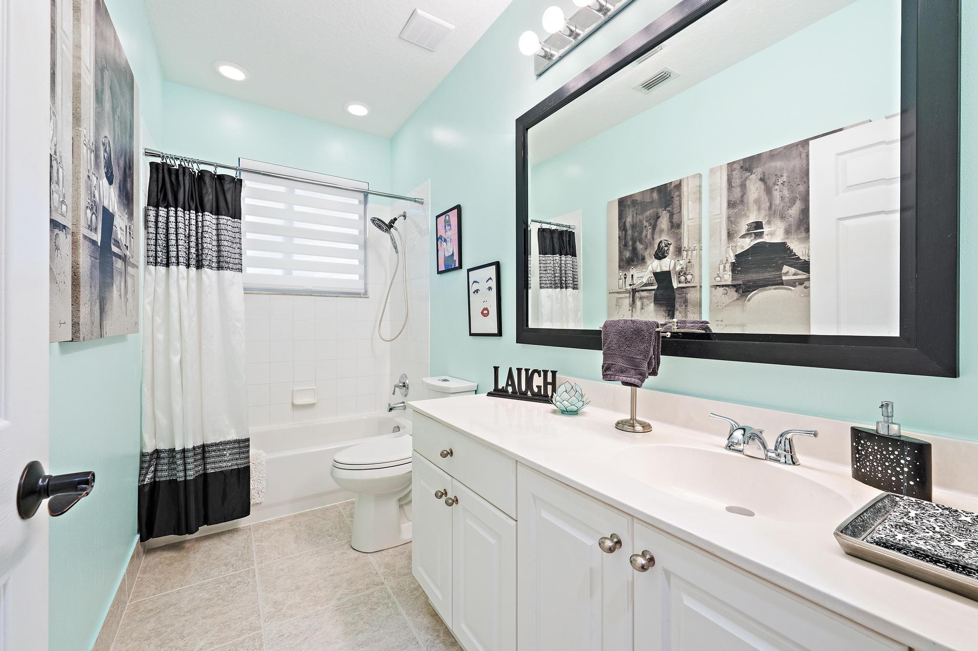 265 Swallowtail Lane Jupiter, FL 33458 - Photo 18 of 37 a bathroom with a double vanity sink mirror and toilet