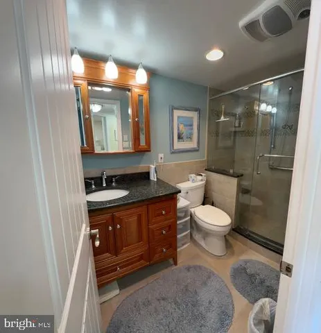 a spacious bathroom with a toilet sink and mirror