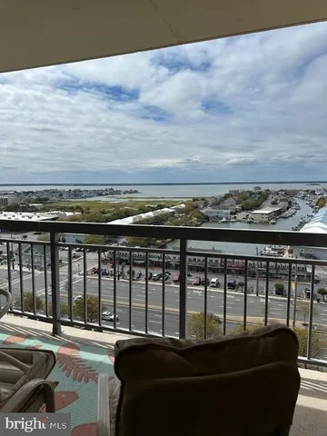 a view of a balcony with chair and city view