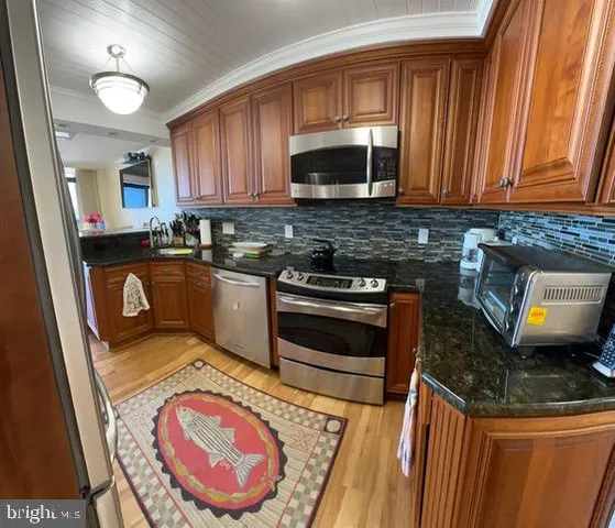 a kitchen with a stove a sink and a microwave