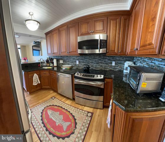 11604 Coastal Highway, Unit 1209 Ocean City, MD 21842 - Photo 4 of 20 a kitchen with a stove a sink and a microwave