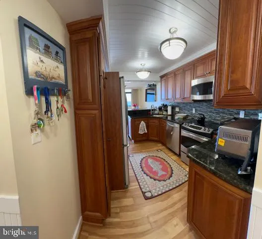 a kitchen with stainless steel appliances granite countertop a refrigerator stove and sink