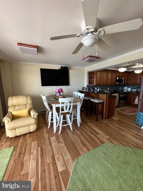 11604 Coastal Highway, Unit 1209 Ocean City, MD 21842 - Photo 7 of 20 a living room with a couch and a wooden floor