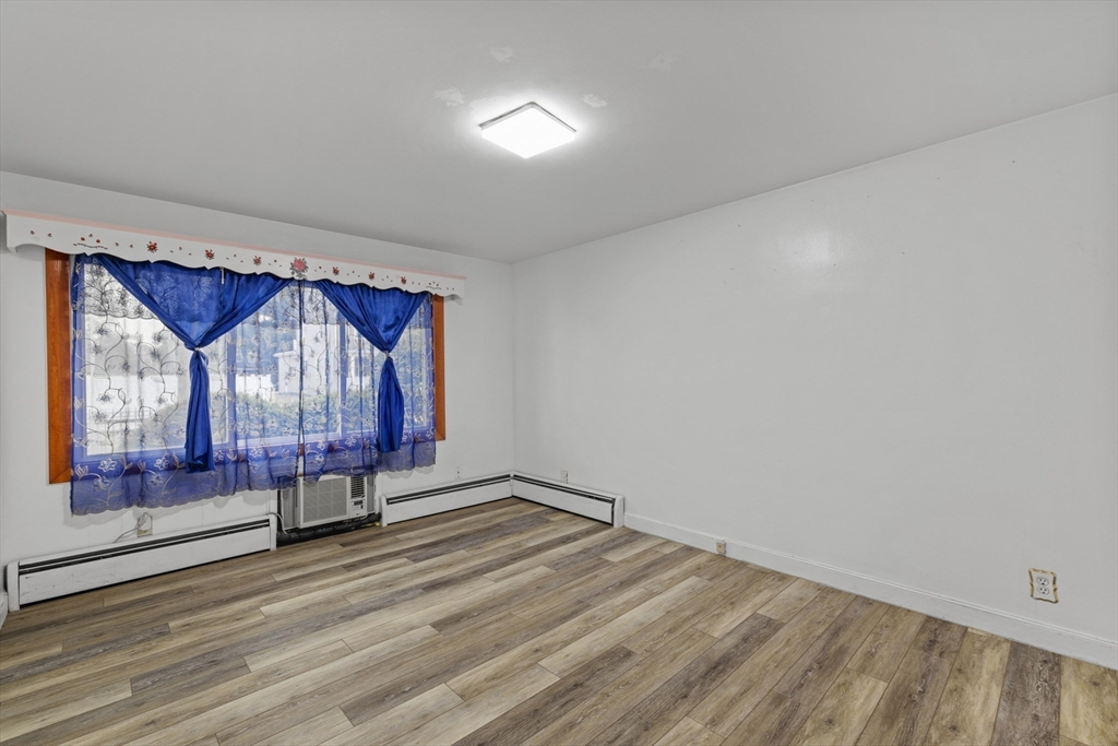 176 River Street Waltham, MA 02453 - Photo 11 of 32 a view of an empty room with wooden floor and a window