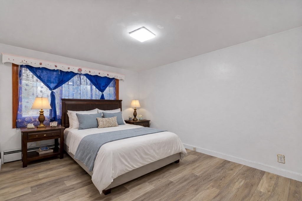 176 River Street Waltham, MA 02453 - Photo 12 of 32 a bedroom with a bed and a night stand