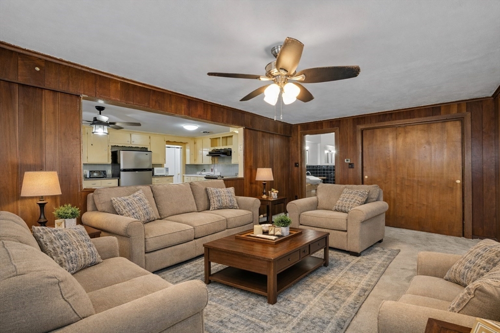 176 River Street Waltham, MA 02453 - Photo 15 of 32 a living room with furniture ceiling fan and a rug