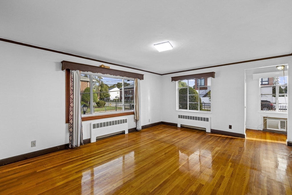 176 River Street Waltham, MA 02453 - Photo 2 of 32 a view of an empty room with window wooden floor and windows