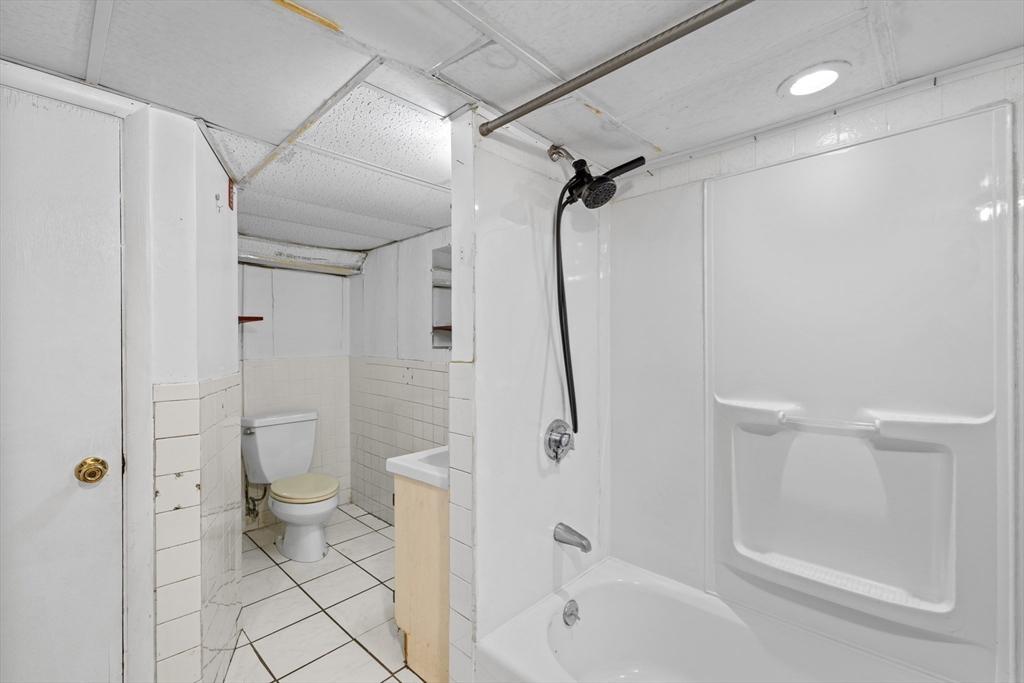 176 River Street Waltham, MA 02453 - Photo 21 of 32 a bathroom with a sink a toilet and shower