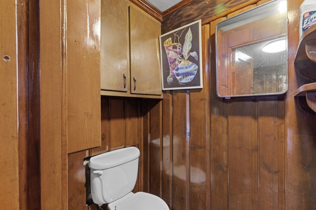 176 River Street Waltham, MA 02453 - Photo 26 of 32 a bathroom with a toilet a sink and glass door