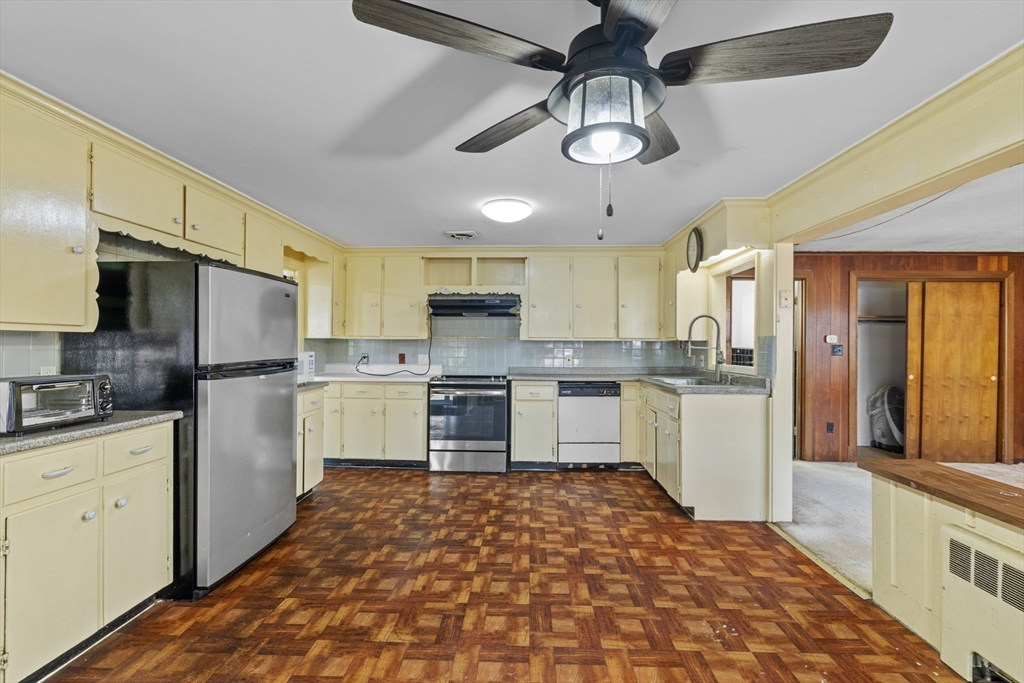 176 River Street Waltham, MA 02453 - Photo 4 of 32 a kitchen with a refrigerator a sink and cabinets
