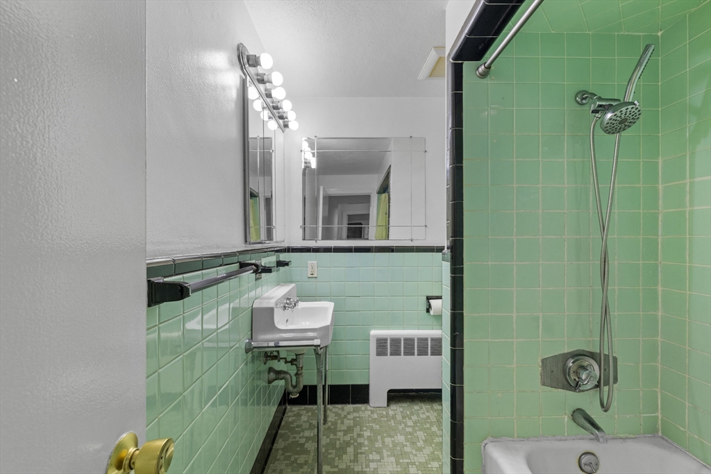 176 River Street Waltham, MA 02453 - Photo 8 of 32 a bathroom with a sink mirror and toilet