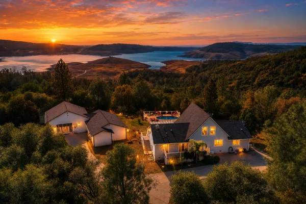 a view of a houses with a swimming pool and mountains