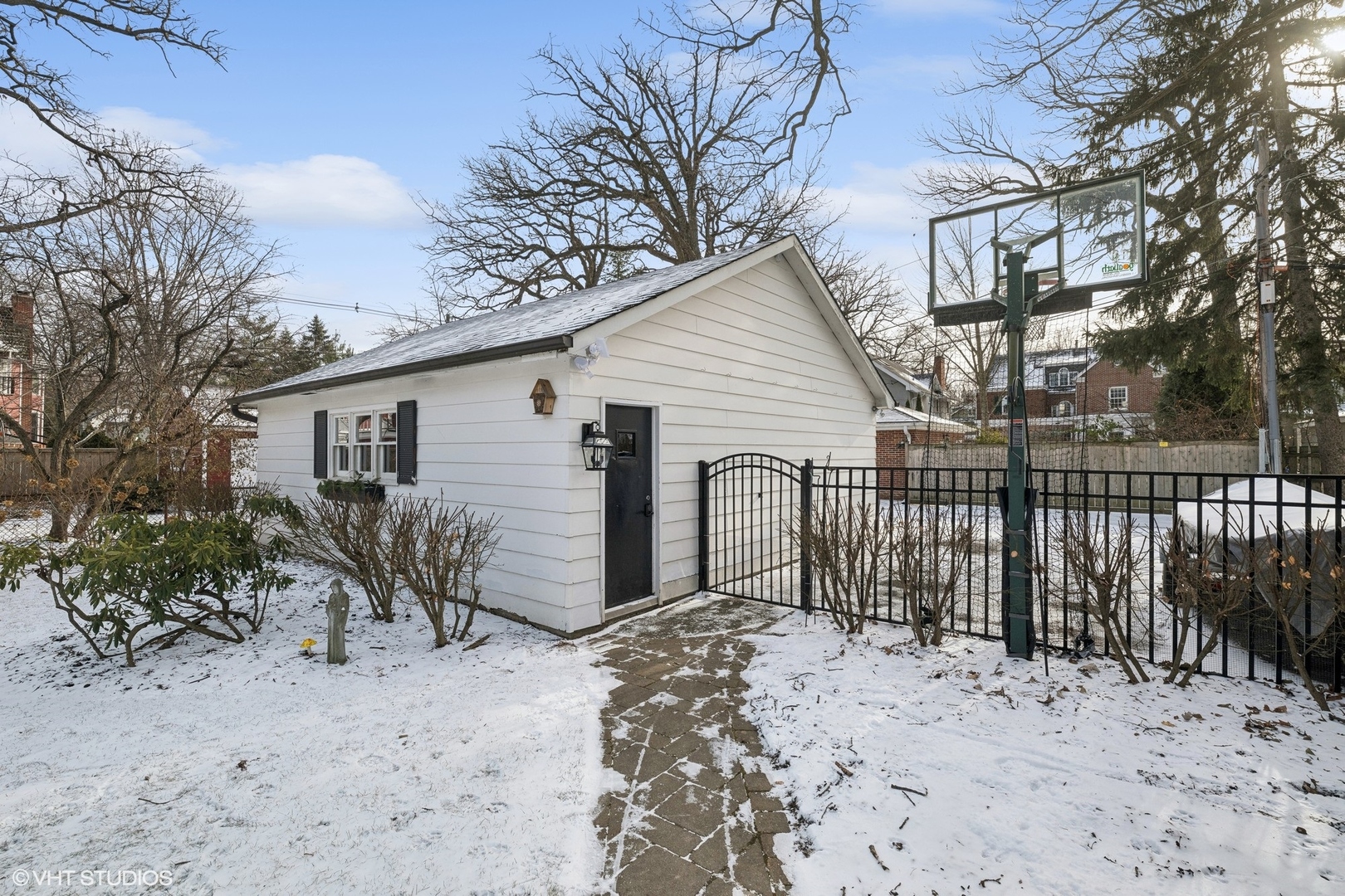 621 Maple Avenue Wilmette, IL 60091 - Photo 40 of 45 a view of a house with a wooden fence next to a yard