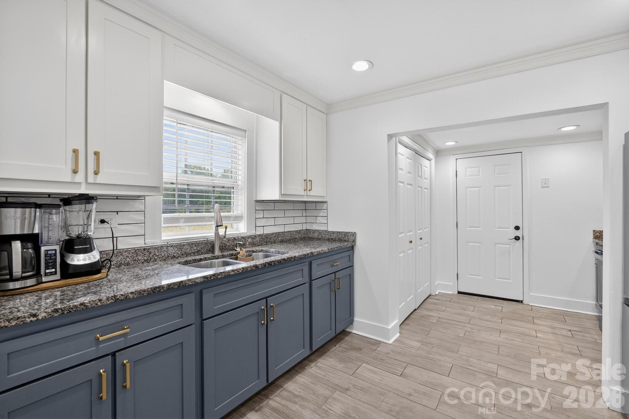 2076 Connelly Springs Road Lenoir, NC 28645 - Photo 16 of 47 a kitchen with granite countertop a sink and a window