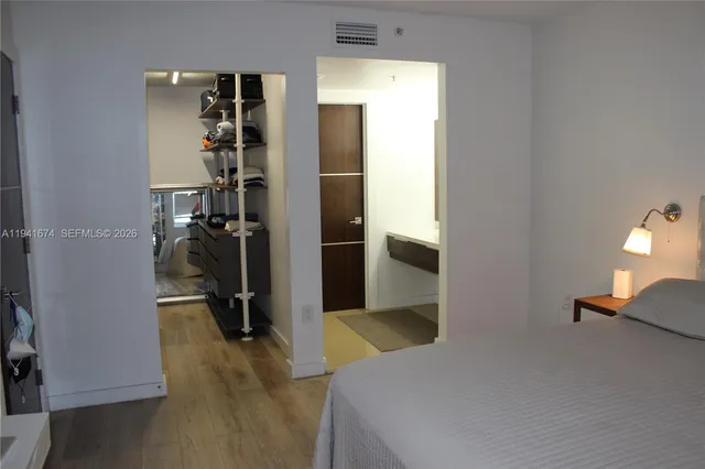 a bedroom with a bed and a view of bathroom