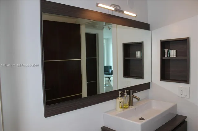 a bathroom with a sink and a mirror
