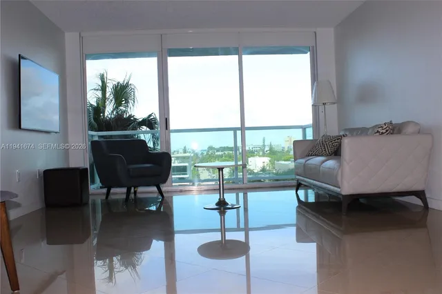 a living room with furniture and a floor to ceiling window