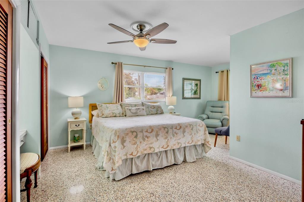 223 Roberts Road Nokomis, FL 34275 - Photo 15 of 27 a bedroom with a large bed and a ceiling fan