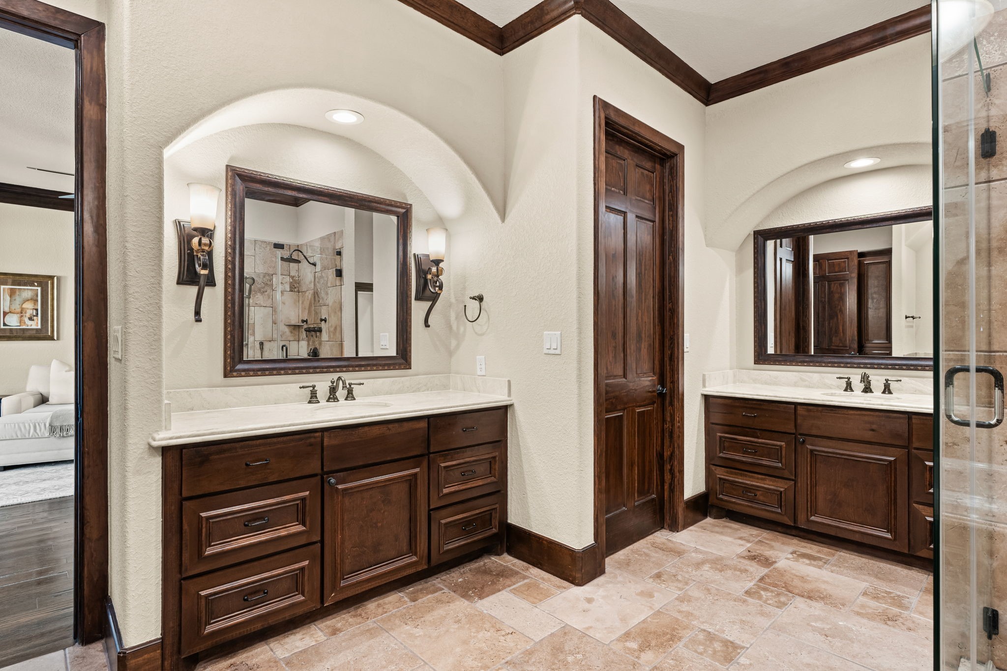3751 Aberdeen Way Houston, TX 77025 - Photo 19 of 39 A generously sized primary bath featuring dual vanities, arched architectural detailing, and refined stone surfaces, offering a bright, well-balanced space designed for comfort and everyday luxury.