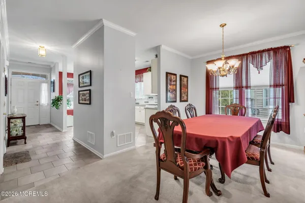 a dining room with furniture and window