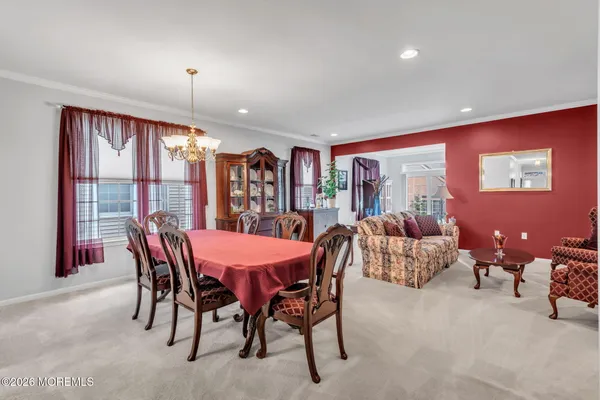 a living room with furniture a large window and bookshelf