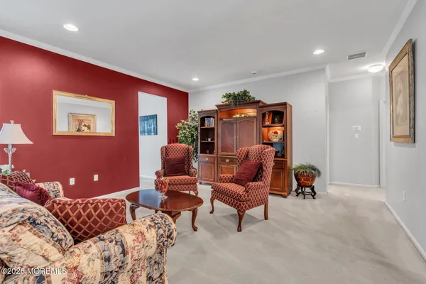 a living room with furniture a ceiling fan and a rug