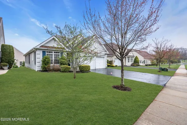 a front view of house with yard and green space