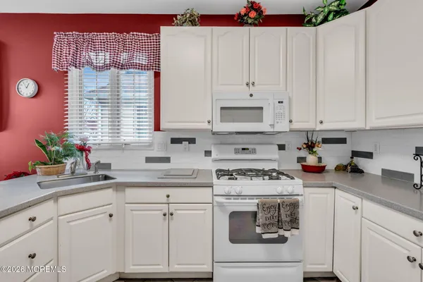 a kitchen with stainless steel appliances granite countertop a stove sink and cabinets
