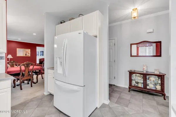 a kitchen that has a lot of cabinets a sink and a refrigerator