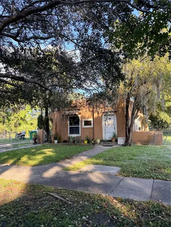 a view of a house with backyard and tree s