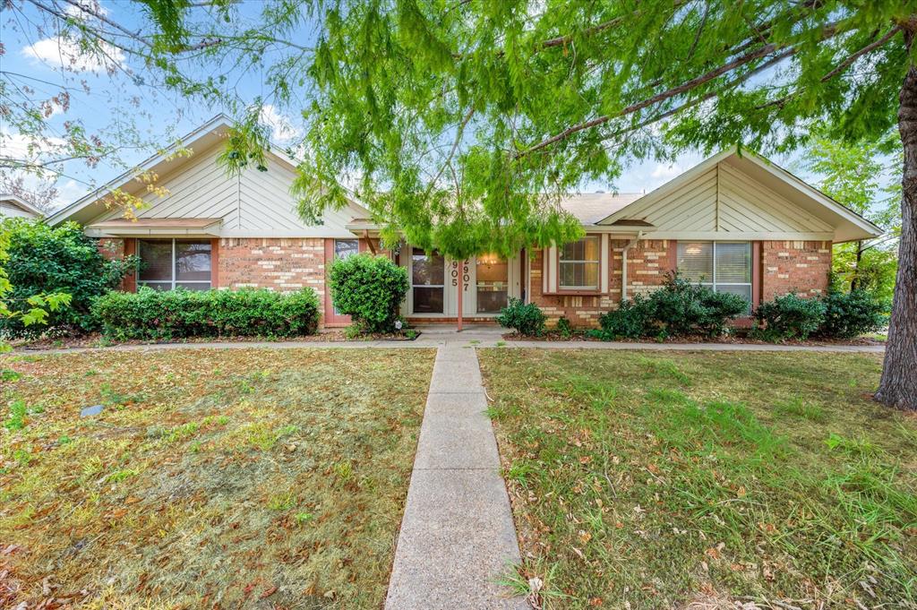 a front view of a house with yard and green space