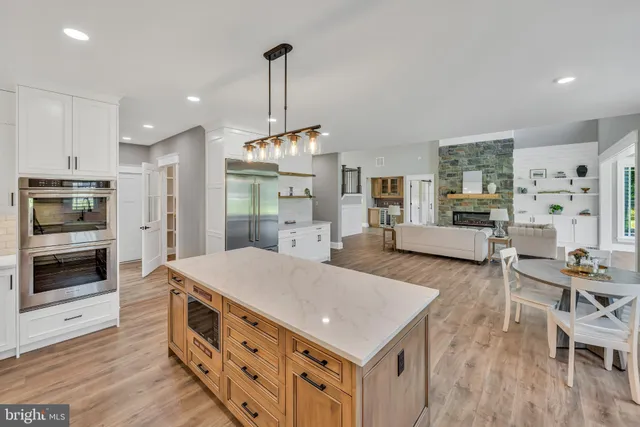 a kitchen with stainless steel appliances a stove sink and microwave