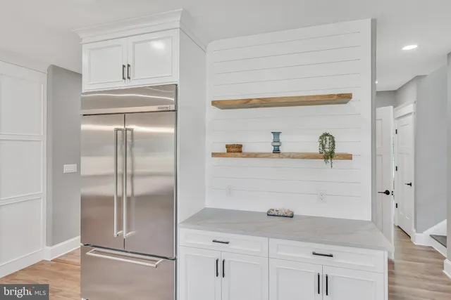a kitchen with cabinets and a refrigerator