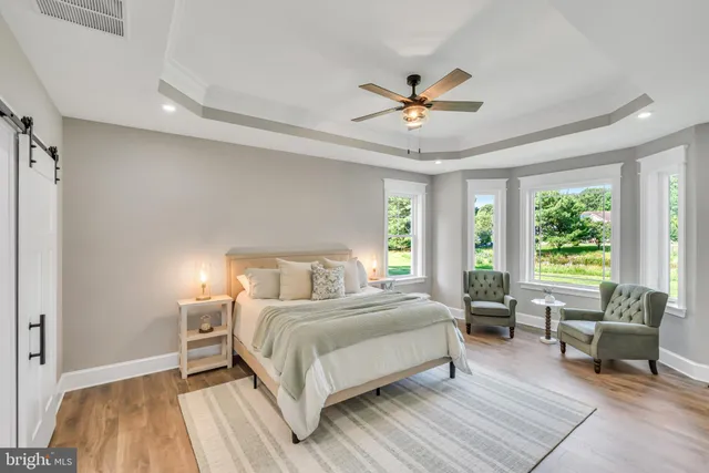 a bedroom with a bed and a view of balcony