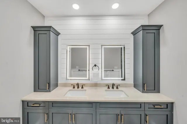 a bathroom with a sink vanity and a mirror