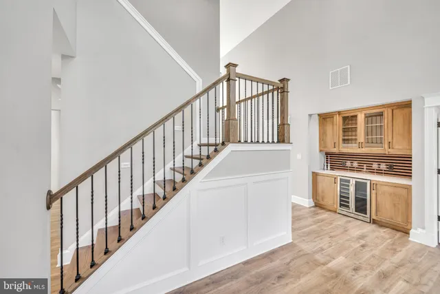 a view of a kitchen with stainless steel appliances and white cabinets