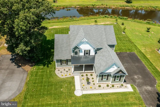 an aerial view of a house with a big yard