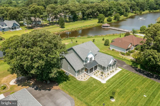 an aerial view of residential house with outdoor space and lake view