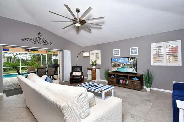 a living room with furniture a fireplace and a large window