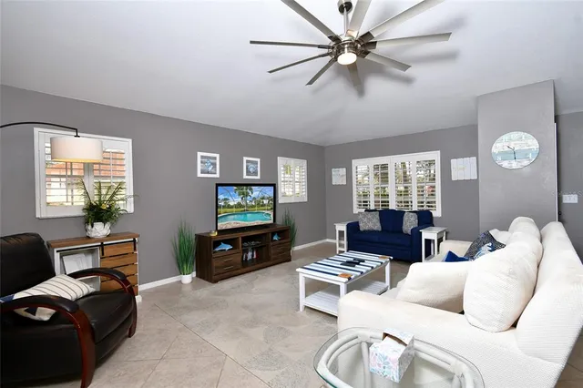 a living room with furniture a window and a flat screen tv