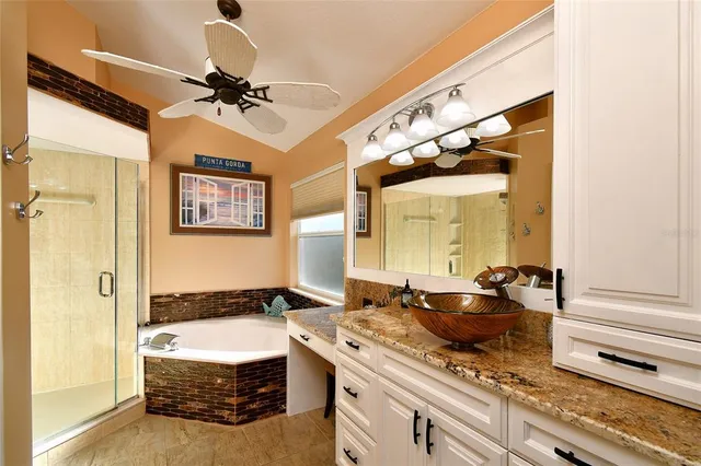 a spacious bathroom with a granite countertop sink and a mirror